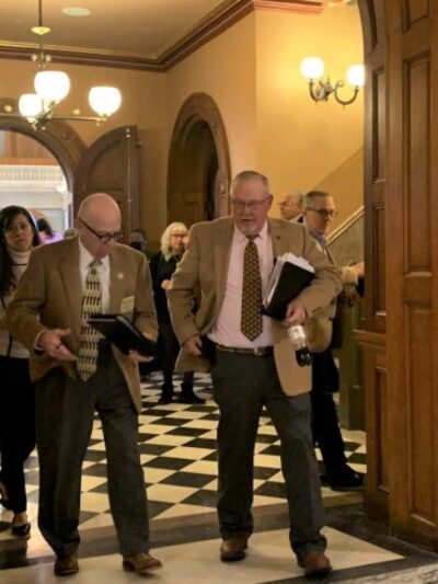 Lawmakers leave the Kansas House chamber after voting to override the governor's veto of the redistricting plan. Blaise Mesa / Kansas News Service