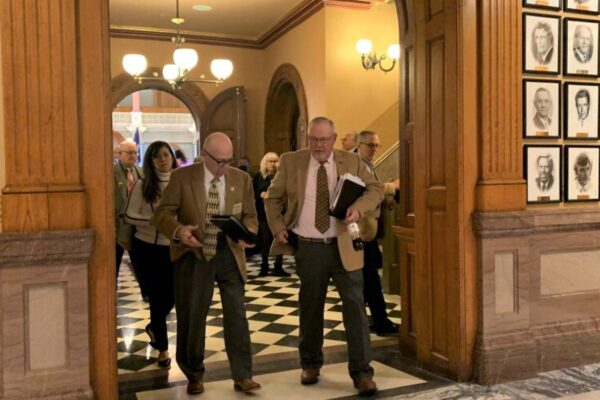 Lawmakers leave the Kansas House chamber after voting to override the governor's veto of the redistricting plan. Blaise Mesa / Kansas News Service