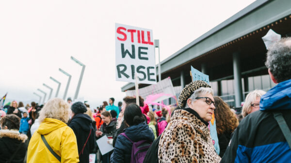 crowd of protesters with sign STILL, WE RISE