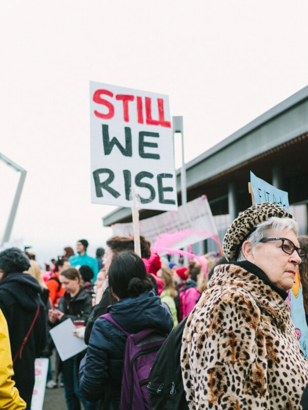 crowd of protesters with sign STILL, WE RISE