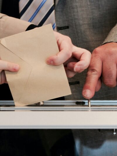 Putting ballot into ballot box