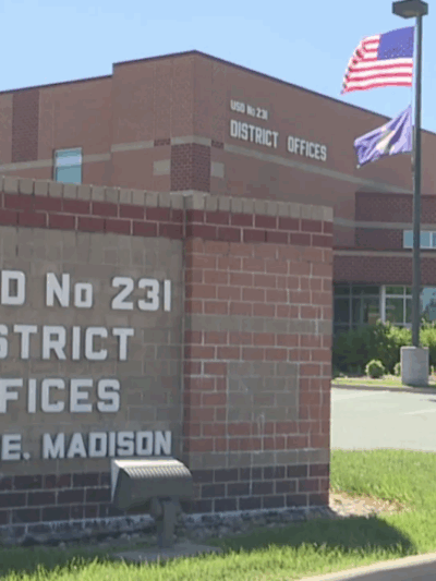 School sign reads: USD No 231 DISTRICT OFFICES 231 E. MADISON
