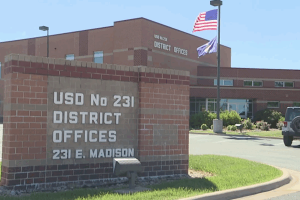 School sign reads: USD No 231 DISTRICT OFFICES 231 E. MADISON
