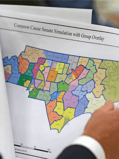 Person holding and reading district map