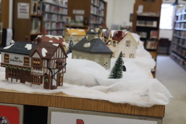 zoomed in photo on christmas display of a miniature village with quaint buildings and snow