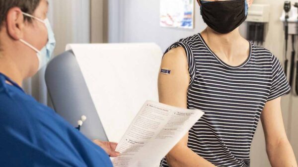 Person receiving healthcare from medical professional