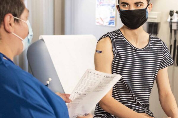 Person receiving healthcare from medical professional