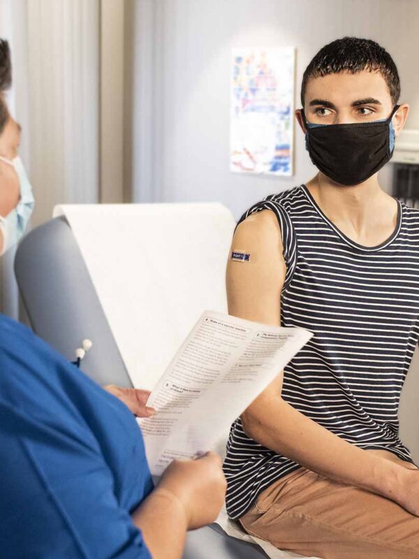 Person receiving healthcare from medical professional