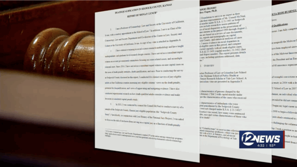 Screengrab of news video showing paper copies of expert testimony for the trial