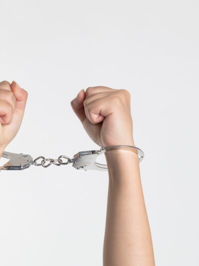 Hands in handcuffs white background