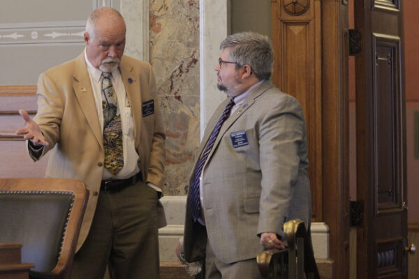 Kansas state Reps. Michael Murphy (left) (R-Sylvia) and Kyle Hoffman (right) (R-Coldwater) confer during a House debate on overriding Democratic Gov. Laura Kelly's veto of a transgender bathroom bill, Thursday, April 27, 2023. | John Hanna/AP Photo