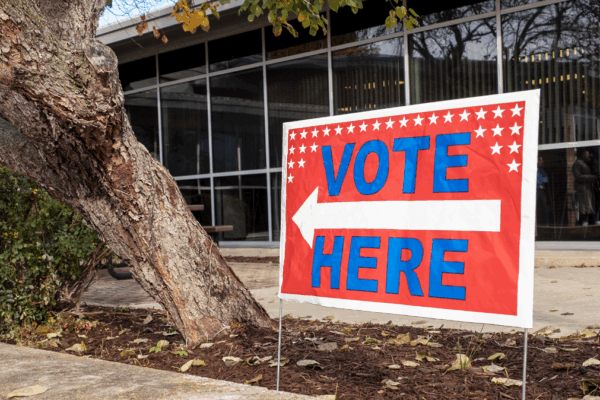 A “vote here” sign is displayed Oct. 25, 2022, at the Shawnee County Election Office in Topeka. (Sherman Smith/Kansas Reflector)