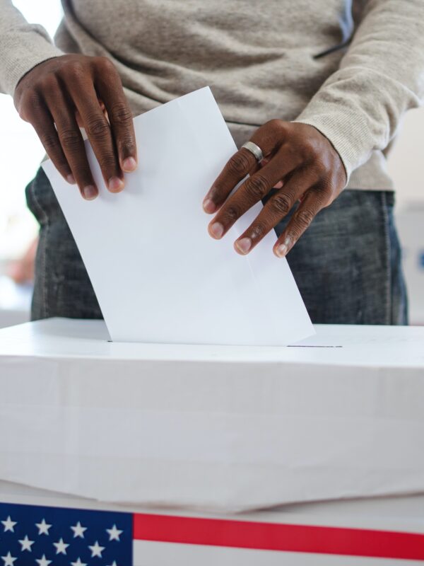 Man putting ballot into ballot box