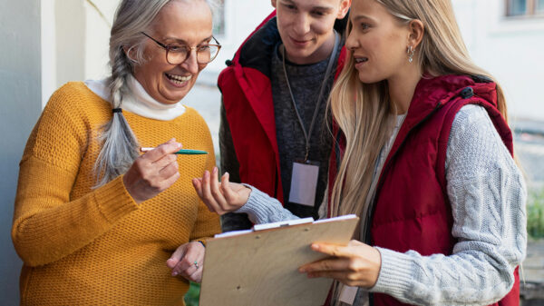 People signing a petition by a door