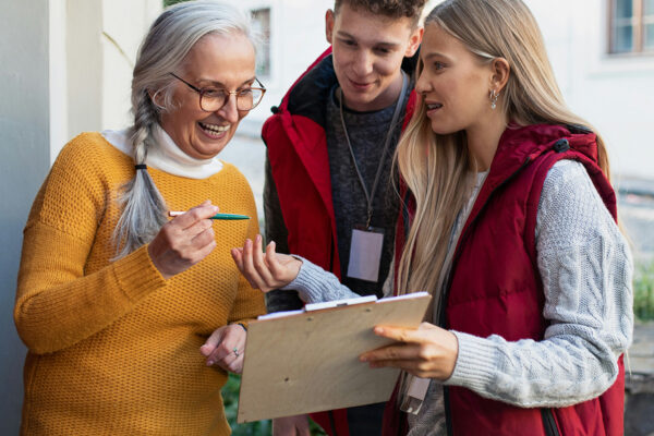 People signing a petition by a door