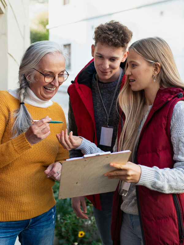 People signing a petition by a door