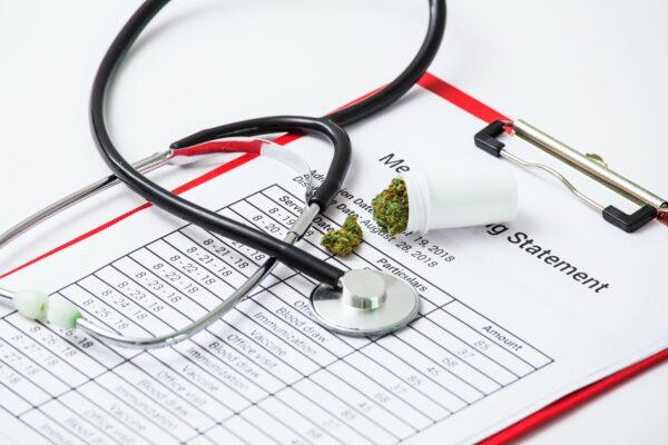Stethoscope and medical marijuana on clipboard