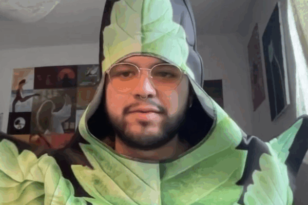 Alejandro Rangel-Lopez, in a plant-oriented costume, contributed to a panel discussion about reasons for the 2024 Legislature to consider adopting a bill legalizing medical cannabis. (Kansas Reflector screen capture from online forum hosted by Kansas Cann