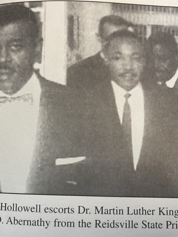 Black and white image from newspaper, caption reads: Attorney Hollowell escorts Dr. Martin Luther King, Jr. «as Rev. Ralph D. Abernathy from the Reidsville State Prison in 1960