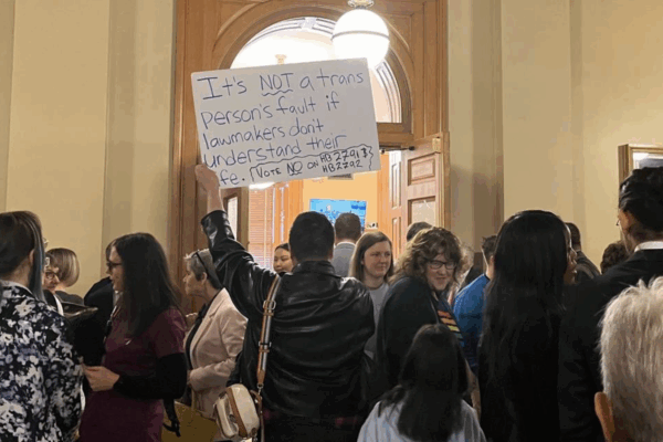 Sign reading, "It's NOT a trans Person's fault if lawmakers don't understand their life."