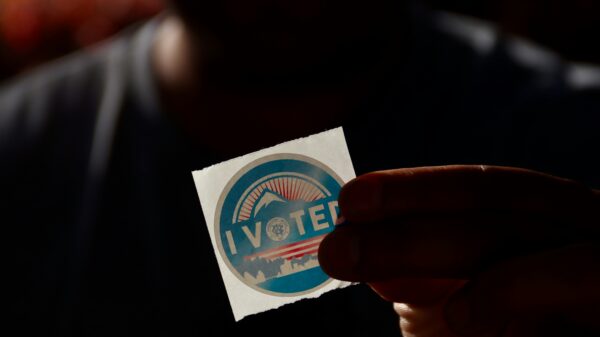 Person holding "i vote" sticker