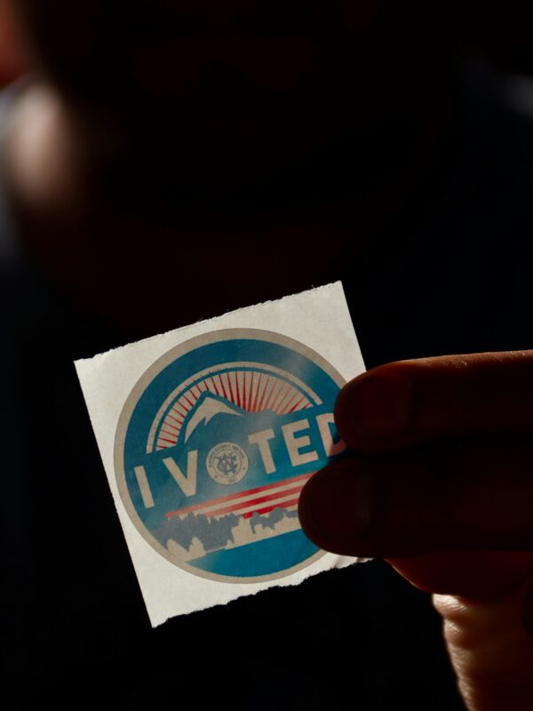 Person holding "i vote" sticker