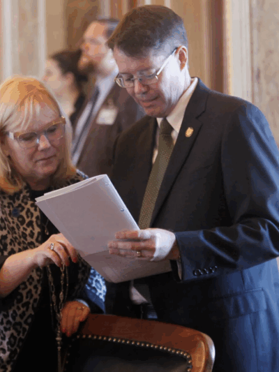 Kansas state Reps. Susan Concannon, left, R-Beloit, and Fred Patton, right, R-Topeka, confer during a session of the House, Thursday, April 6, 2023, at the Statehouse in Topeka, Kan. (JOHN HANNA/AP PHOTO)