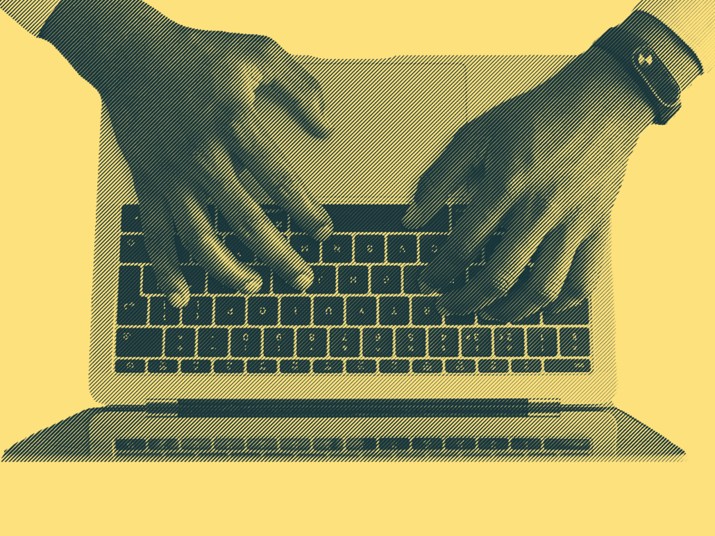 A person typing on a laptop