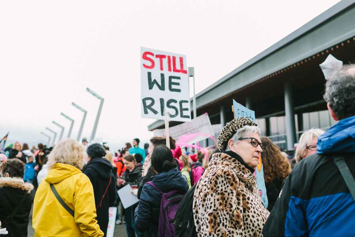 crowd of protesters with sign STILL, WE RISE