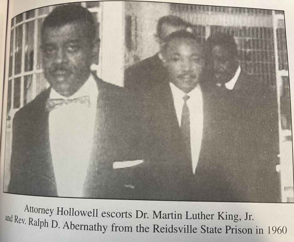 Black and white image from newspaper, caption reads: Attorney Hollowell escorts Dr. Martin Luther King, Jr. «as Rev. Ralph D. Abernathy from the Reidsville State Prison in 1960