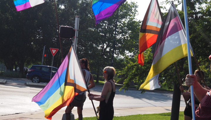  Ahead of SB 180’s implementation, Lawrence campaigners lobby for the city to be made into a sanctuary city for transgender Kansans on June 20, 2023. (Rachel Mipro/Kansas Reflector)