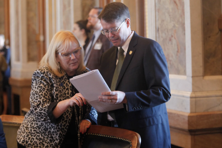 Kansas state Reps. Susan Concannon, left, R-Beloit, and Fred Patton, right, R-Topeka, confer during a session of the House, Thursday, April 6, 2023, at the Statehouse in Topeka, Kan. (JOHN HANNA/AP PHOTO)