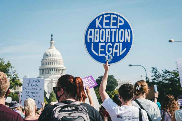 Rally at capitol featuring sign that reads, "Keep abortion legal"