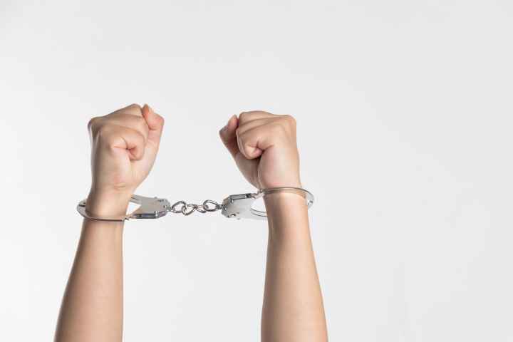 Hands in handcuffs white background