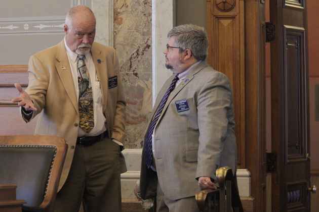 Kansas state Reps. Michael Murphy (left) (R-Sylvia) and Kyle Hoffman (right) (R-Coldwater) confer during a House debate on overriding Democratic Gov. Laura Kelly's veto of a transgender bathroom bill, Thursday, April 27, 2023. | John Hanna/AP Photo