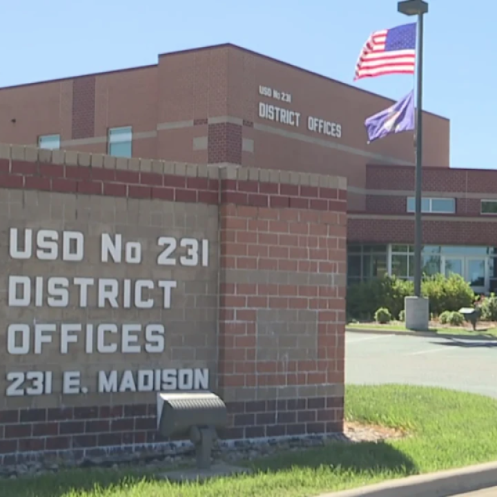 School sign reads: USD No 231 DISTRICT OFFICES 231 E. MADISON