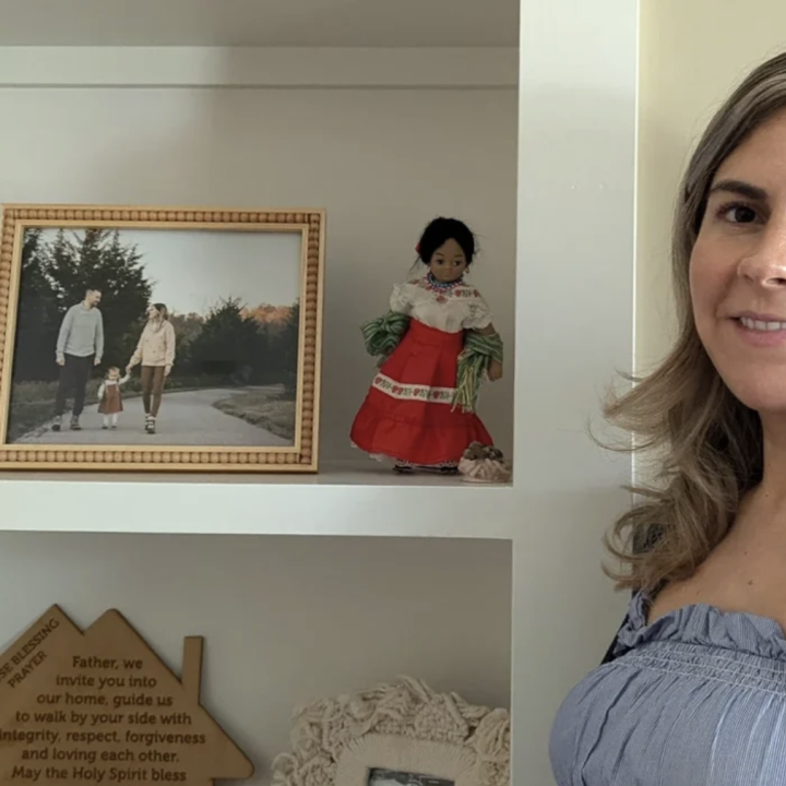 Cindy Phillips stands by a shelf filled with family photos and Mexican-themed dolls. "Its a daily reminder of my heritage for me and my daughter," she said. Lawrence Brooks IV/KCUR 89.3