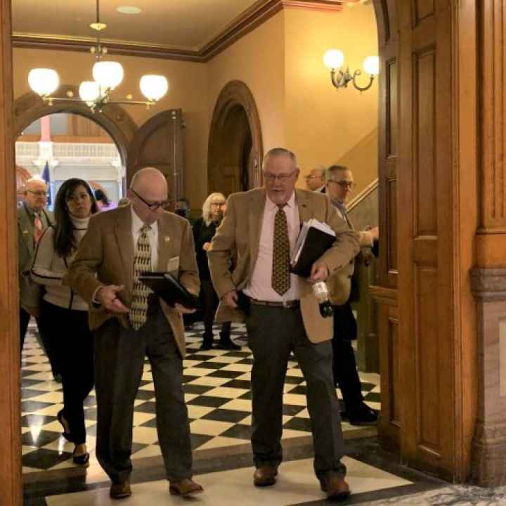 Lawmakers leave the Kansas House chamber after voting to override the governor's veto of the redistricting plan. Blaise Mesa / Kansas News Service