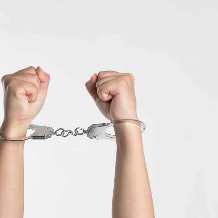 Hands in handcuffs white background