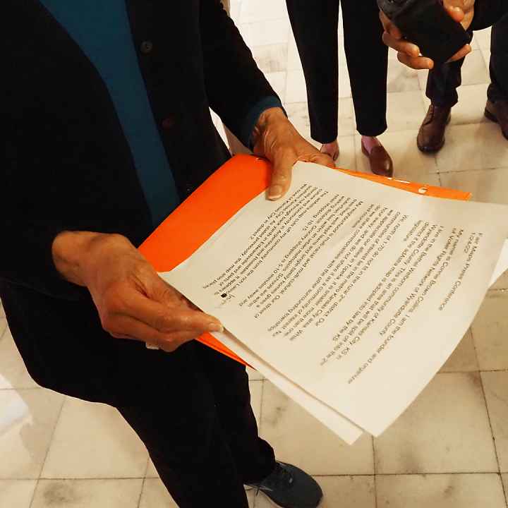  Connie Brown Collins, a Kansas City, Kansas, resident, holds her notes during a news conference to condemn the GOP-drawn congressional map on Jan. 24, 2022, at the Statehouse in Topeka. (Sherman Smith/Kansas Reflector)